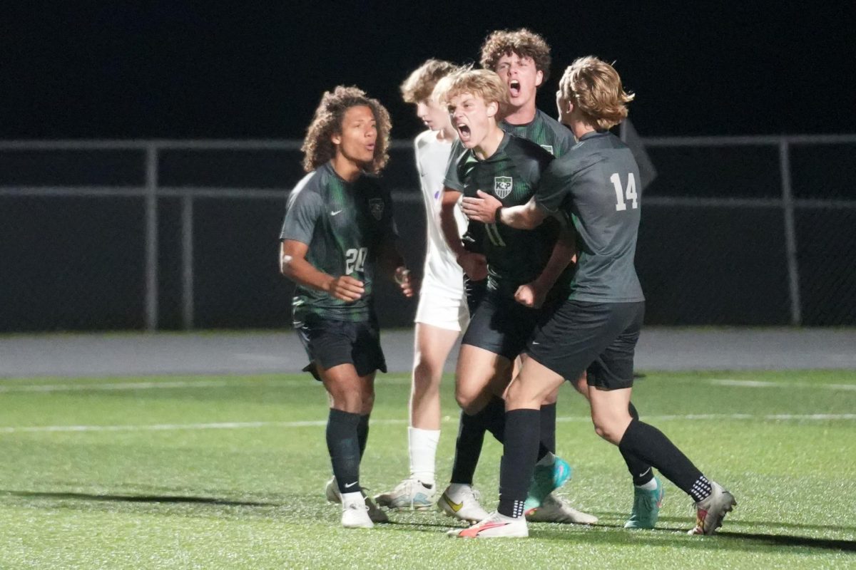 Senior Evan Jimerson reacts after scoring the teams first goal as freshman Kye Wehby, sophomore Ronan Flaherty and junior Chase Bennett surround him. Jimersons goal cut the teams deficit to 2-1 against Hallsville in the first round of the playoffs. The Panthers went on to win 5-2.