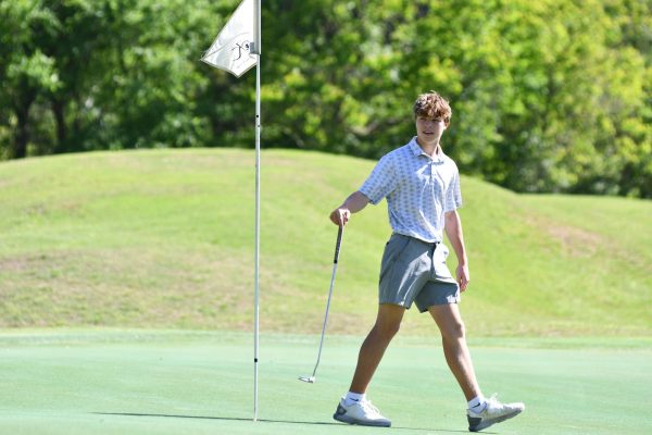 Sophomore Cory Case walks away after recording a par on the second hole at Kingwood Country Club in the District Meet. He was in second place after the first round with a 77. 