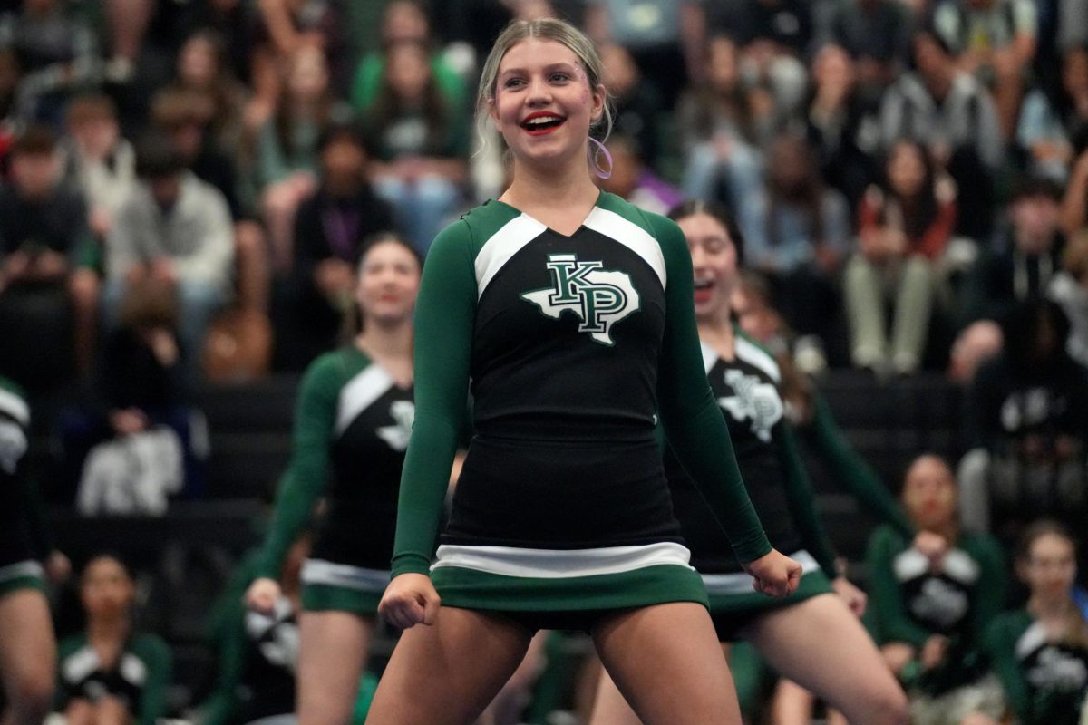 Junior Abigail Smith cheers during the final pep rally of the year with the competition cheer team.