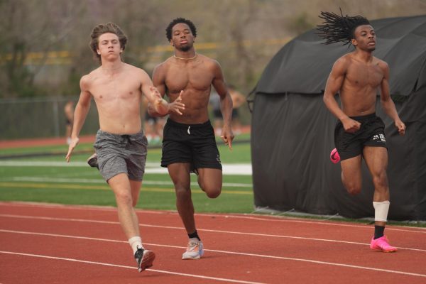 During practice in March, senior Wyatt May, junior Aaron Andrews and senior Deshaun Martin run sprints. Each have been key among the sprinters this season. 
