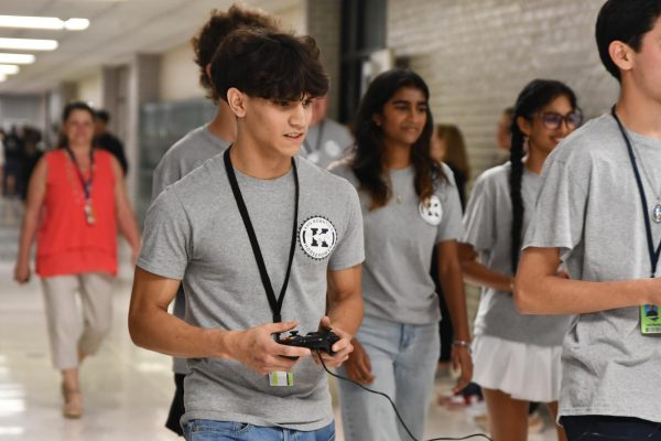 Senior Guillermo Cote uses a remote to drive the robotics teams robot through the halls during a state sendoff on April 2. He and the rest of the robotics team will compete at the state tournament April 4-6. 