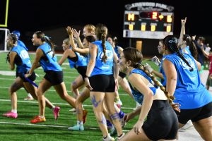 The seniors rush on the field as time runs off the clock in the championship game of the Powder Puff tournament on May 10. 