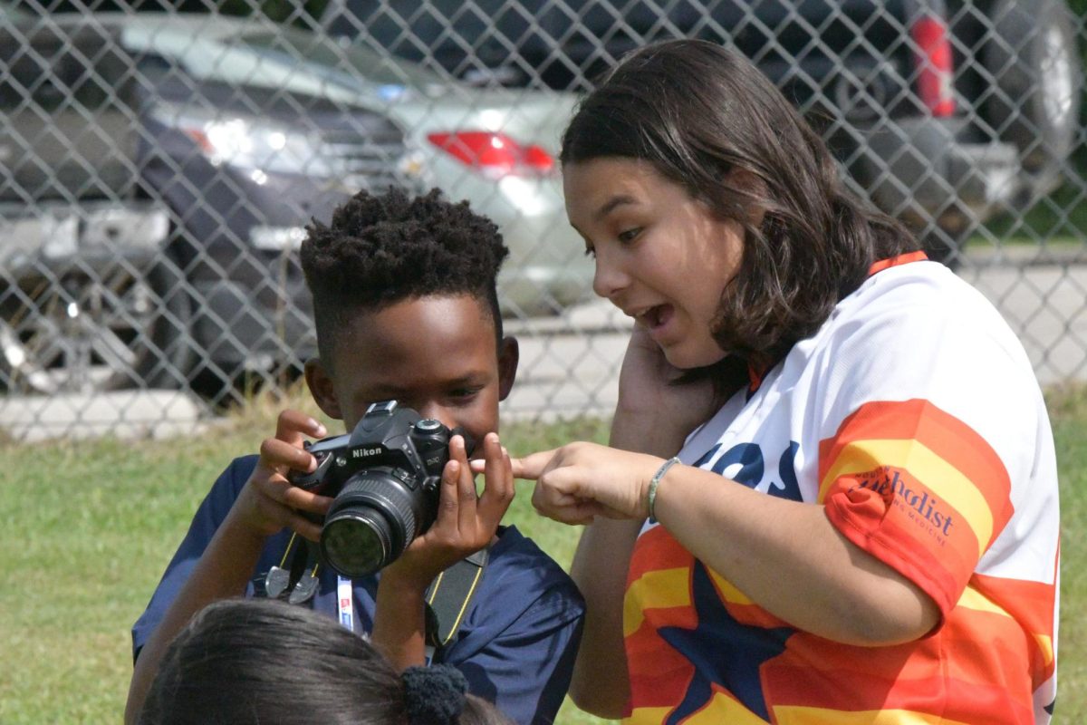 Maya Ortiz helps teach camper Anutu Hood at the Kingwood Park Summer Media Camp in July 2023. She was the 2021 and 2022 NSPA Photojournalist of the Year.
