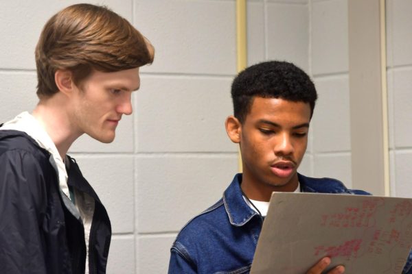 Math teacher Haden Johnson talks with sophomore Selvin Blanco Rodriguez during class on Aug. 29. Johnson was one of 14 new teachers hired over the summer. 