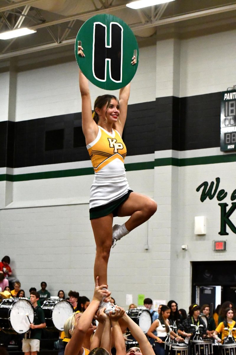 Senior Haley Tappan holds up a sign while the cheer perform at the pep rally on Sep. 6.