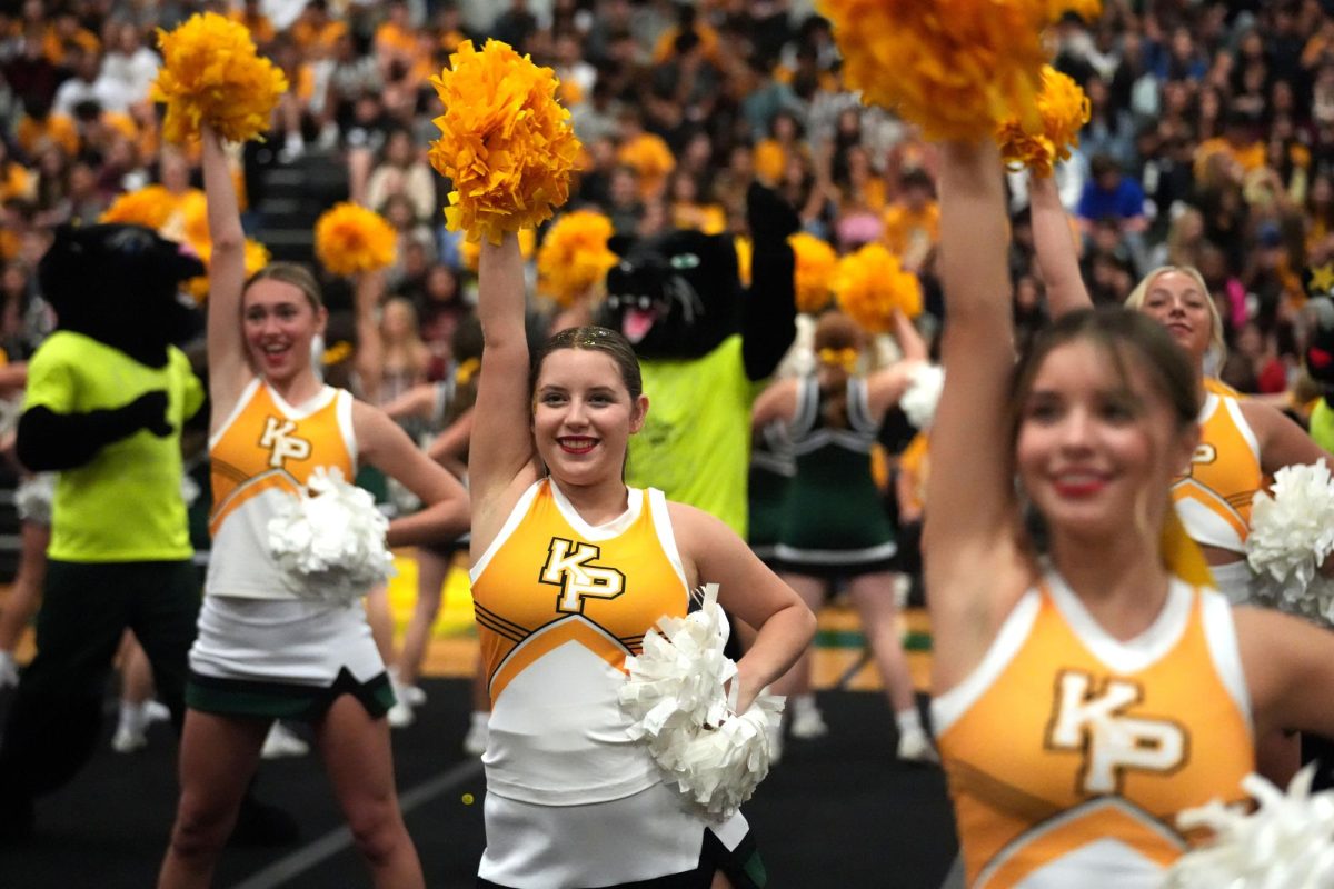 Junior Reese Ivy, senior Melanee Martin-Benavidez and senior Haylee Tappan perform with the cheer team at the Go Gold pep rally.