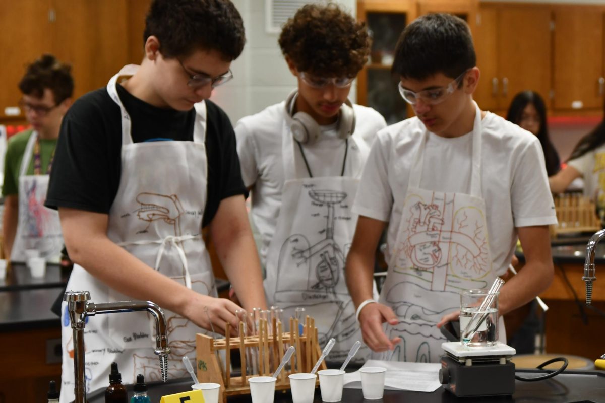 Freshmen Steven Jackson, Fabio Salima and Victor Motiu work on the murder mystery lab in Advanced Biology this year.