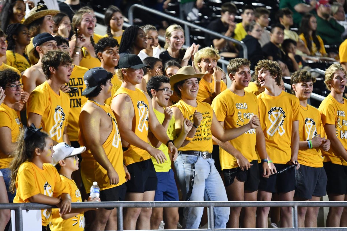 The student section wore all gold as the program honored children and families impacted by pediatric cancer. 