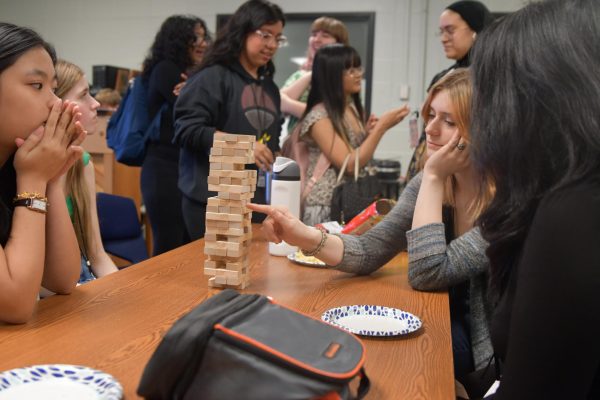 Junior Elizabeth Piquette plays Jenga during an Asian-American Club meeting on Sept. 27.