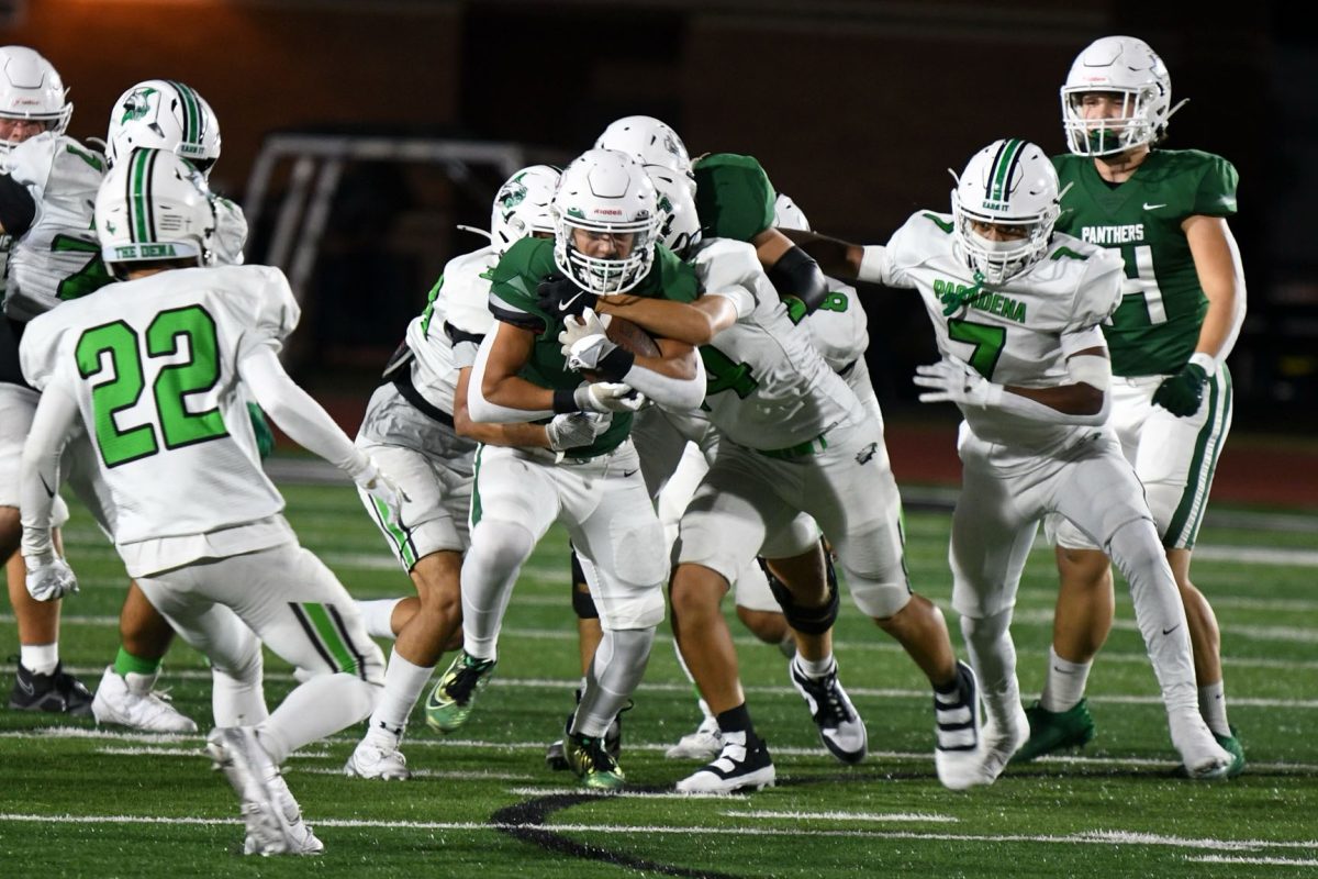 Senior Chris Lora pushes through a gap in the Pasadena defense on Oct. 24. The Panthers won 41-7 on Senior Night. Lora scored one touchdown.