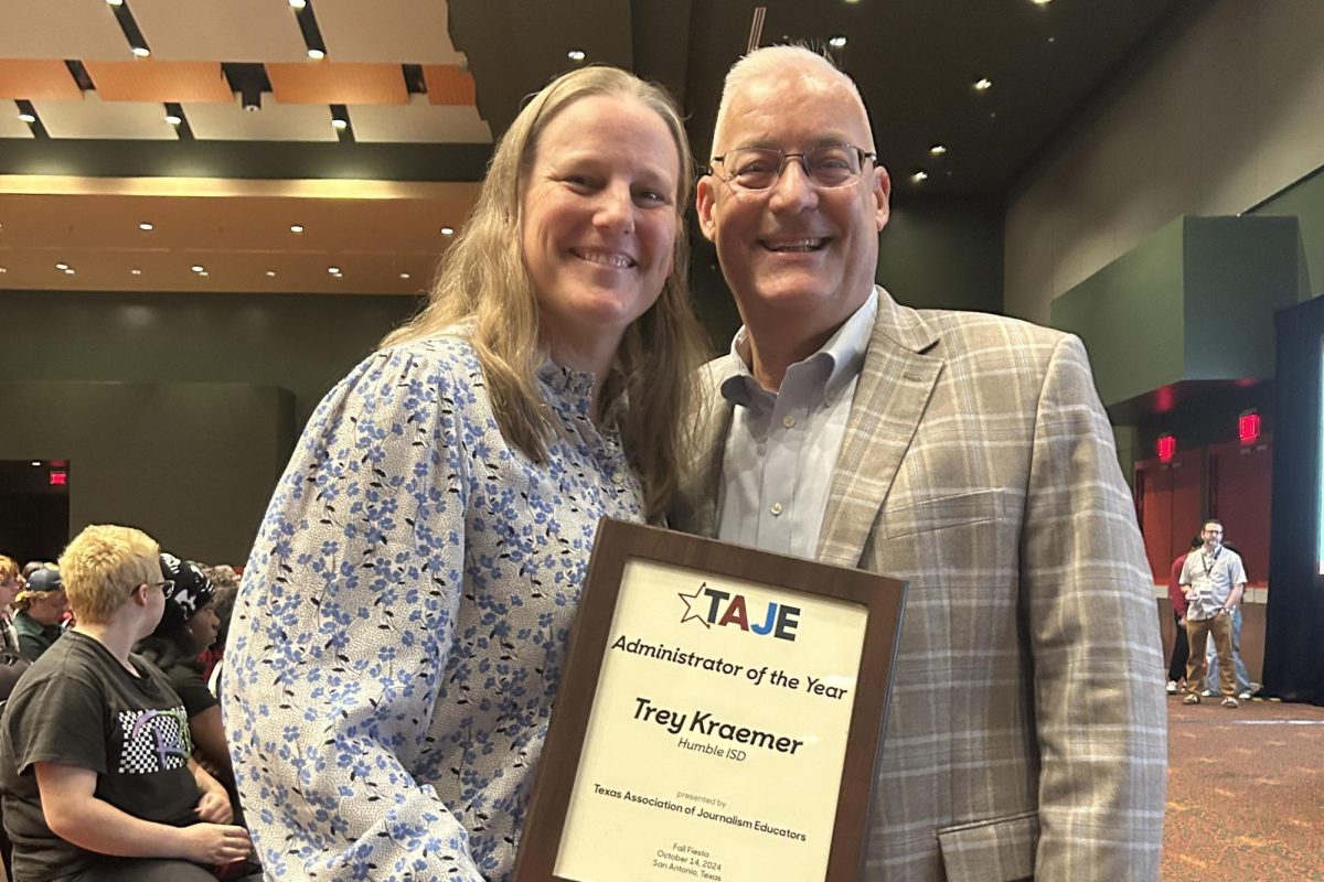 Kingwood Park journalism teacher presented former assistant superintendent Trey Kraemer with his Administrator of the Year honor at the TAJE Fall Fiesta conference on Oct. 12. 