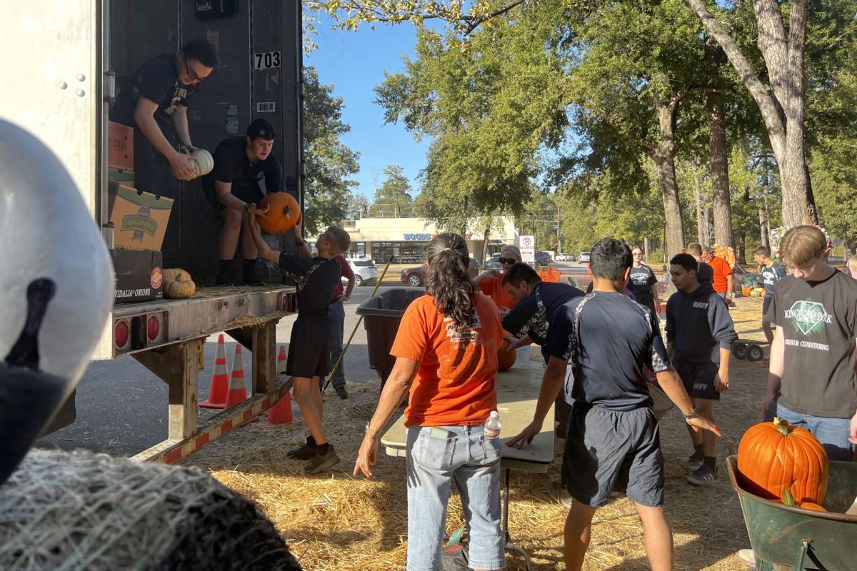 Kingwood Park and Kingwood High JROTC students work to unload 14,000 pounds of pumpkins at Good Shepherd Episcopal's Church on Woodland Hills Drive.