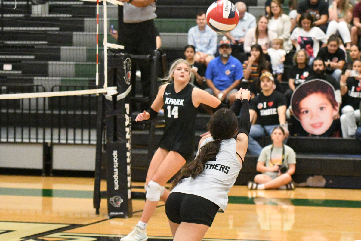 Senior Angie Gonzalez dives to make a pass as junior Kaely Evans prepares to receive it against Splendora.