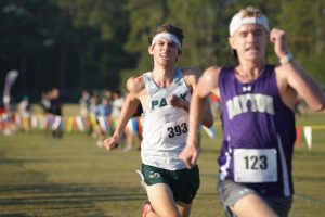 Kingwood Park senior Elijah Merino fights as he watches Dayton junior Jaxon Asbill pass him in the final few meters at the finish line for first place at the District Championships. Merino, who lost by .19 seconds this year, entered the race as the two-time defending champion. 