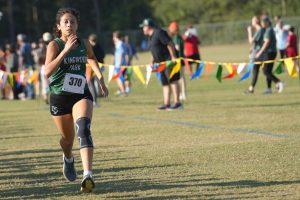 Sophomore Sylvana Lopez Andrade pushes to the finish to take fourth place in the District Championships. She was the top finisher for the Panthers, who took first place as a team. A year ago, Lopez Andrade finished 6th overall in the JV division. 