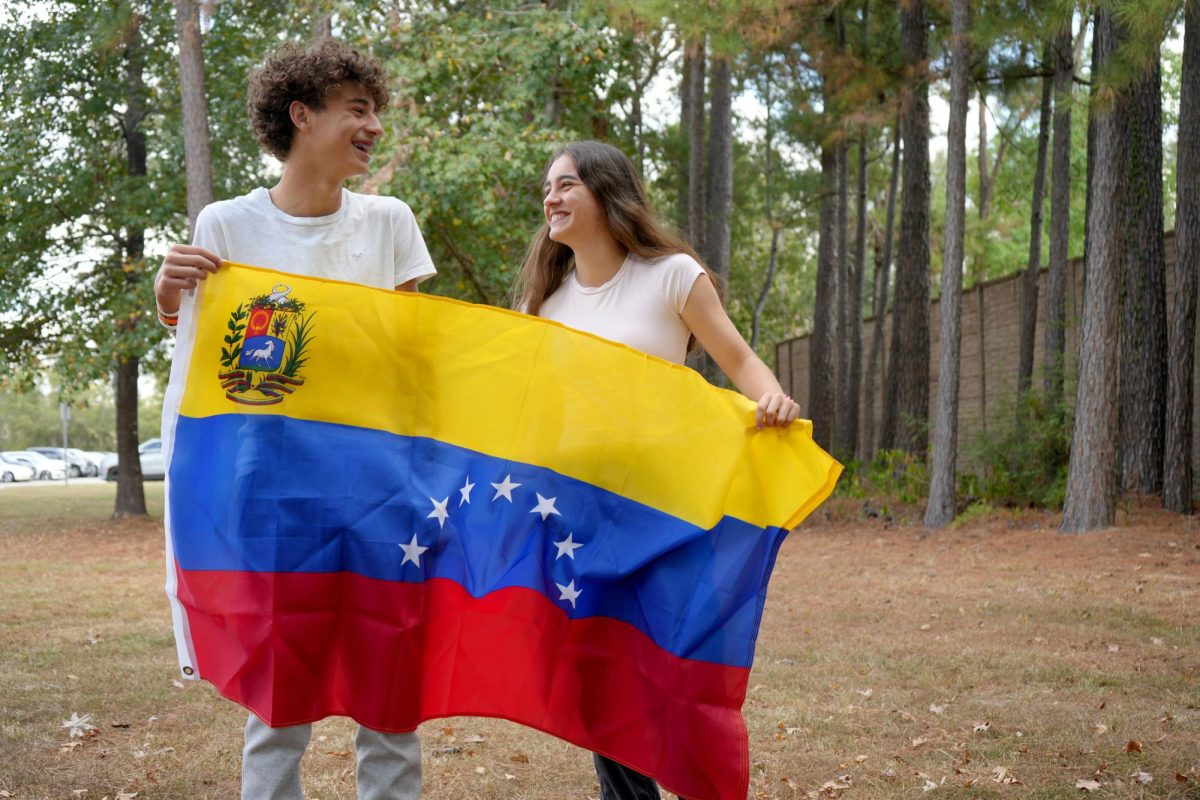 Flavia and Fabio Salima Marcano pose with the Venezuelan flag their family brought with them when they sought political asylum in the United States in 2017. Millions have fled the country in the last decade to escape economic hardship and political repression.