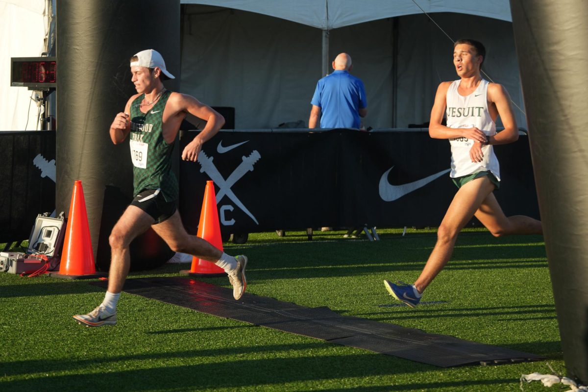 To conclude the varsity 5k, senior Carson Brown sprints across the finish line.
