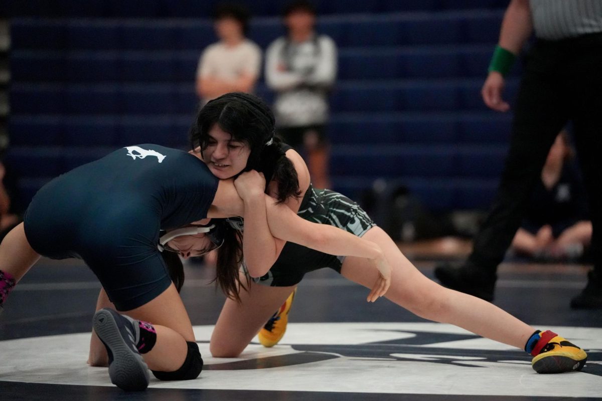 Senior Leah Barron battles with one of the Kingwood wrestlers during a match on Nov. 13.