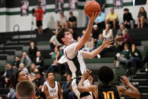 Jacob VanNostrand rises above Spring Woods defenders to lay the ball into the hoop.