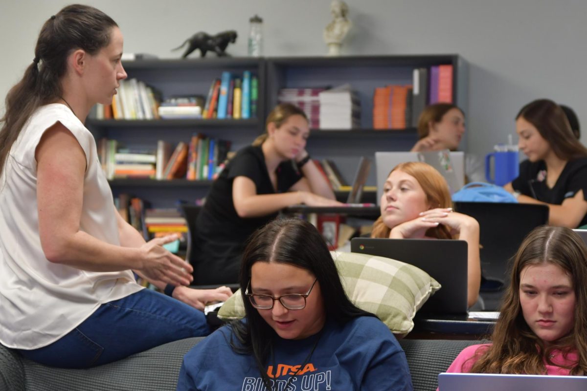 During 6th period Dual Credit English 4, Kimberly Villegas talks with senior Sarah Cahill as students have a work day.