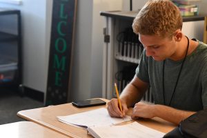 Senior Andrew Carson works on a problem in Calculus AB on Nov. 6. He was one of three seniors who received recognition for their scores on the National Merit PSAT eaxm.