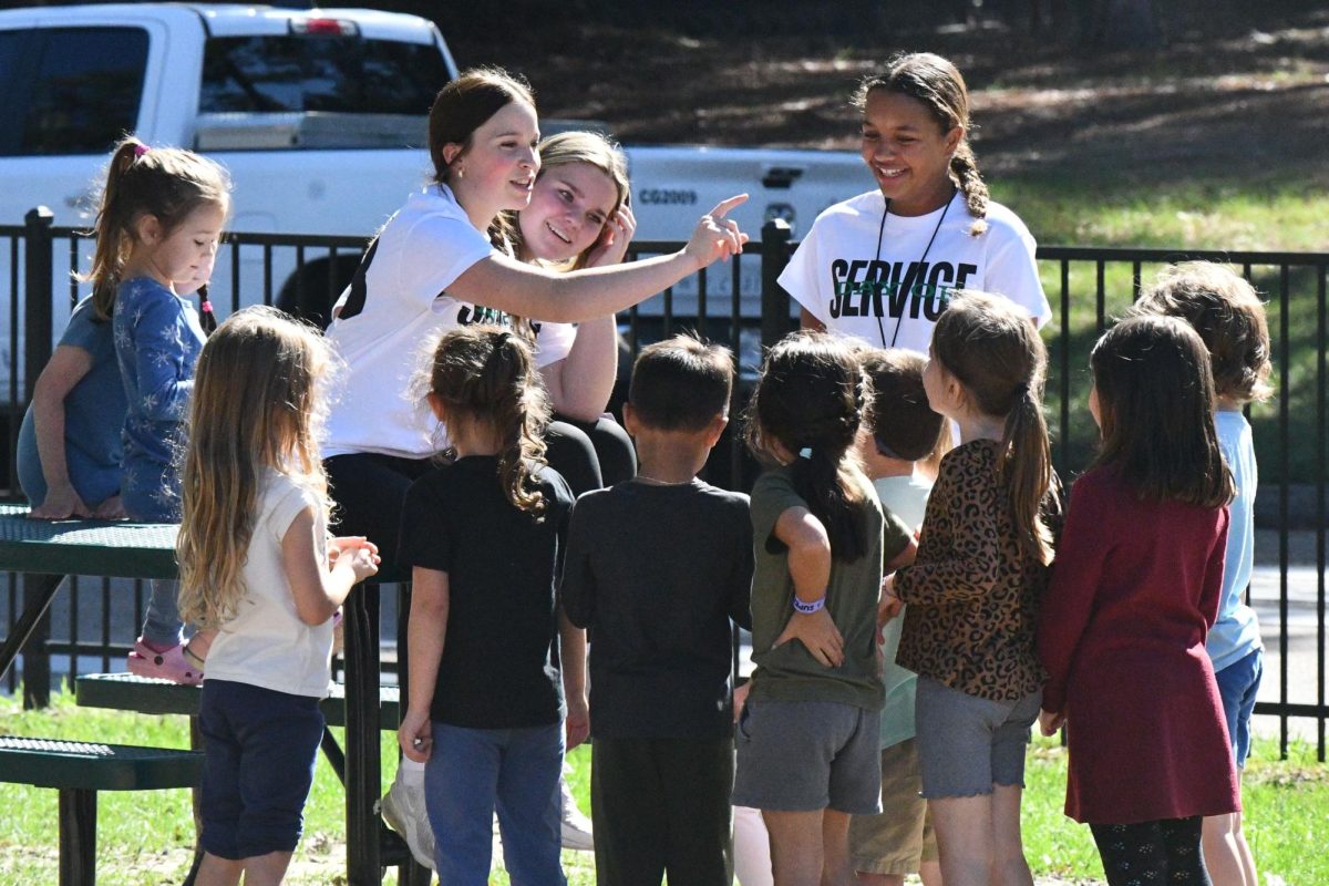 Kiera Crawford, Ailey Davis and Makayla Curmon play with kids during recess at Bear Branch Elementary on Nov. 19. They were part of the freshman class that spent the day at the school helping teachers and entertaining the kids.