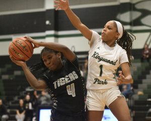 Rionna Martin closely defends A&M Consolidated player and reaches for the ball.