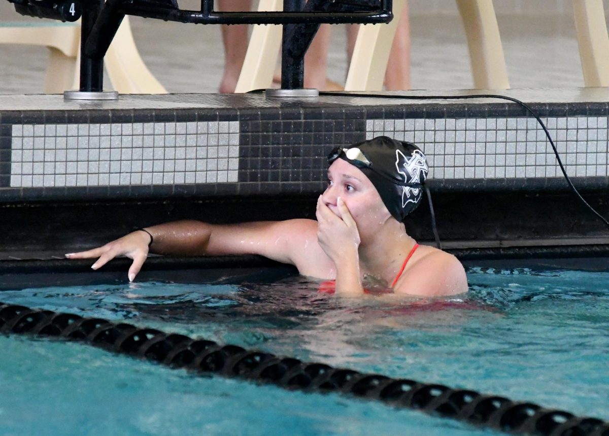 Junior Elena Amos reacts after seeing her time in the 100-meter butterfly against A&M Consolidated. She broke the pool record she set when she was a freshman. 