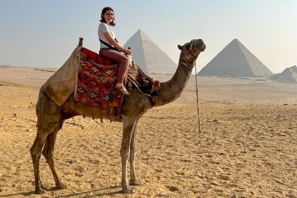 Senior Olivia Brenner participates in a tour on a camel toward the Great Pyramid of Giza. Photo submitted by Olivia Brenner. 