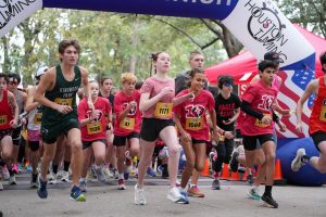 Senior Elijah Merino breaks out in a sprint at the start of the L3 Foundation Turkey Day 5K. He finished first in the event the past two years. 