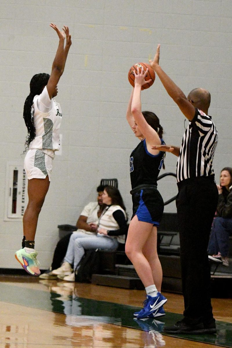 Senior Aniah Cross jumps up trying to block the pass in by a Friendswood player.