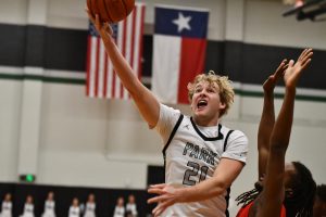 Senior Kallen Cosper goes up for a layup with Crosby defender guarding him closely.