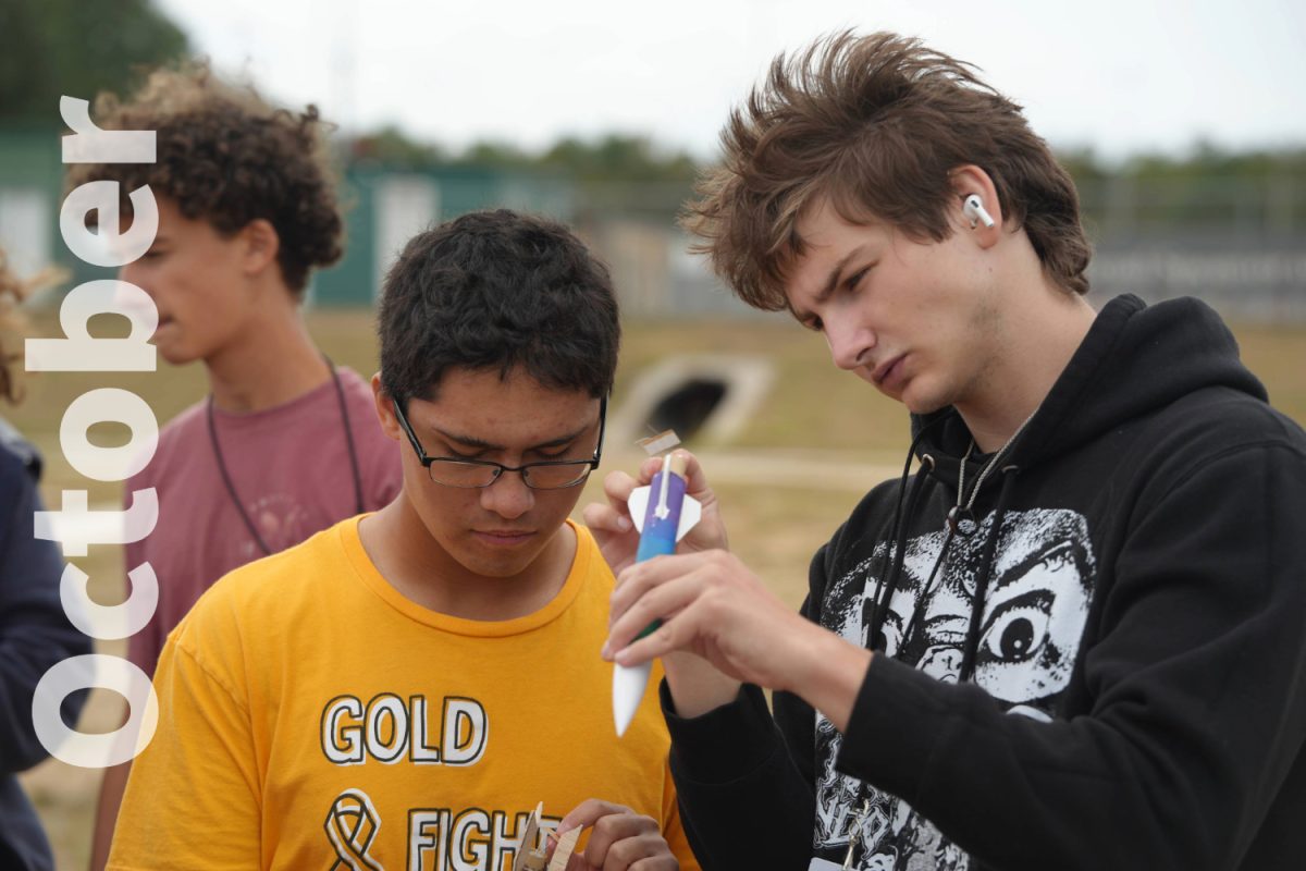 The aeroscience students work to prepare their rocket for launching.