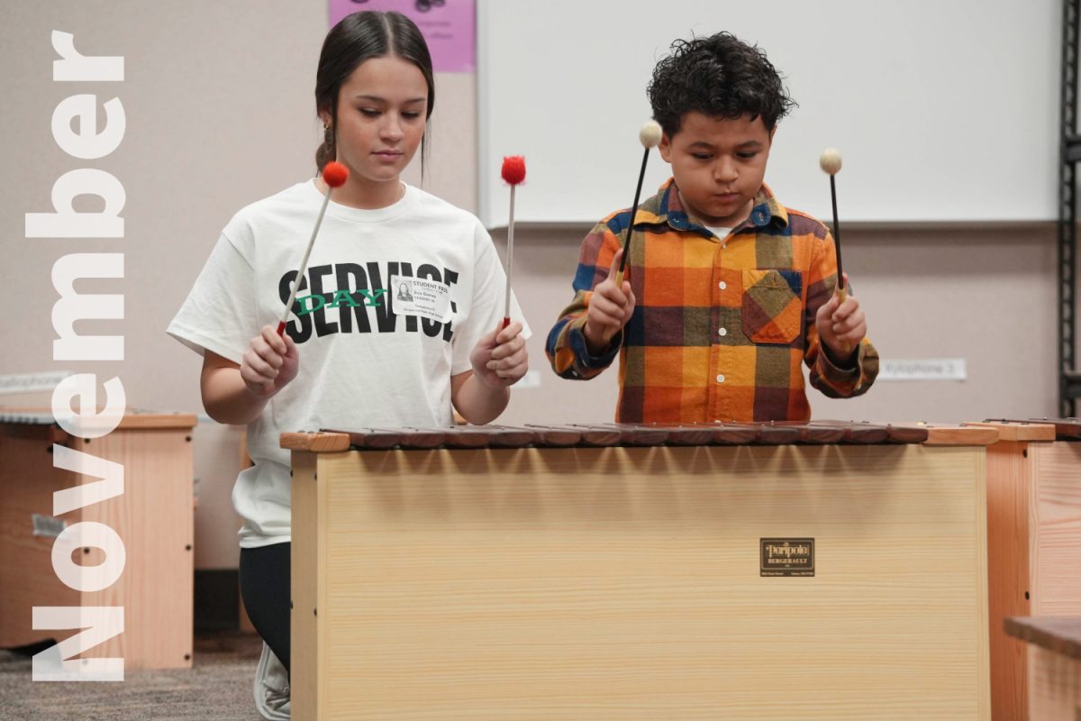 Ava Gomez participates in music class at Elm Grove Elementary. She was one of a group of freshmen who participated in Day of Service at elementary schools around Humble ISD.