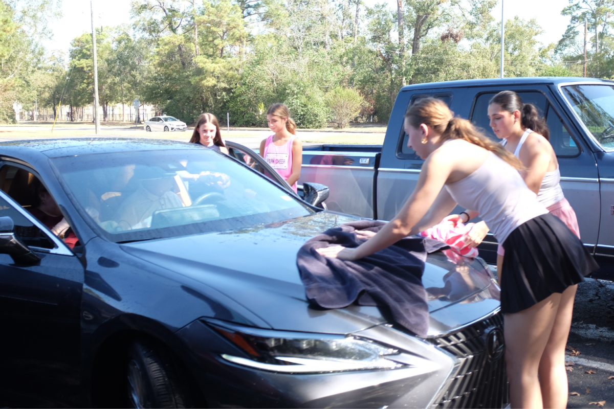 Club members for Girls in Grace wash cars during a fundraiser in October. 