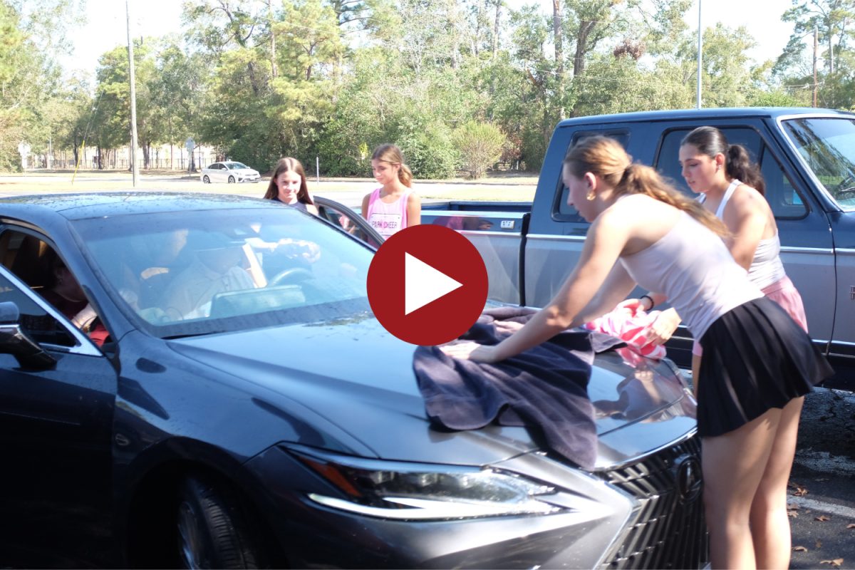 Club members for Girls in Grace wash cars during a fundraiser in October. 