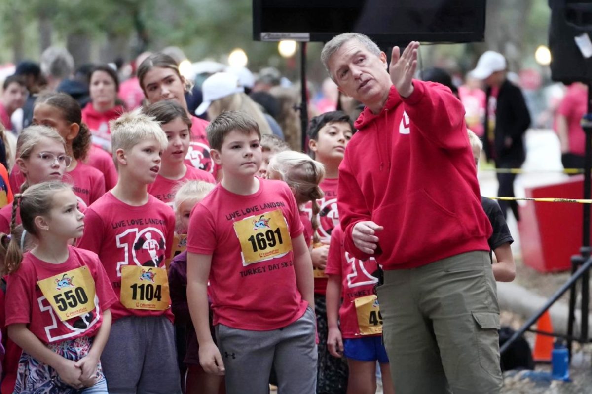 Scott Ahrendt helps direct the children in the 1K prior to the race beginning on Thanksgiving Day. Ahrendt is the founder of the L3 Foundation, which runs the Turkey Day run each year.