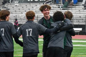 Junior Ronan Flaherty celebrates with his teammates after scoring in the 5-0 victory over Texas City on Jan. 9. 