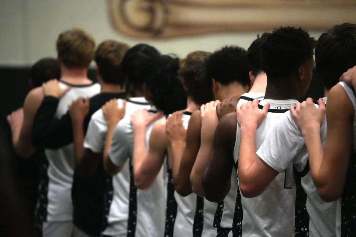 The boys basketball team stands for the National Anthem prior to tip-off against Splendora on Jan. 10. 