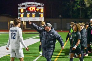 Head athletic trainer Daniel Scalia separates sophomore Kye Wehby from Kingwood midfielder Charles Morrison as the game becomes contentious at the end. The referees called off the game early with the teams in a 2-2 tie.