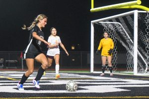 Sophomore forward Maddie Moffitt runs to get an angle to take a shot against Deer Park in the varsity scrimmage.