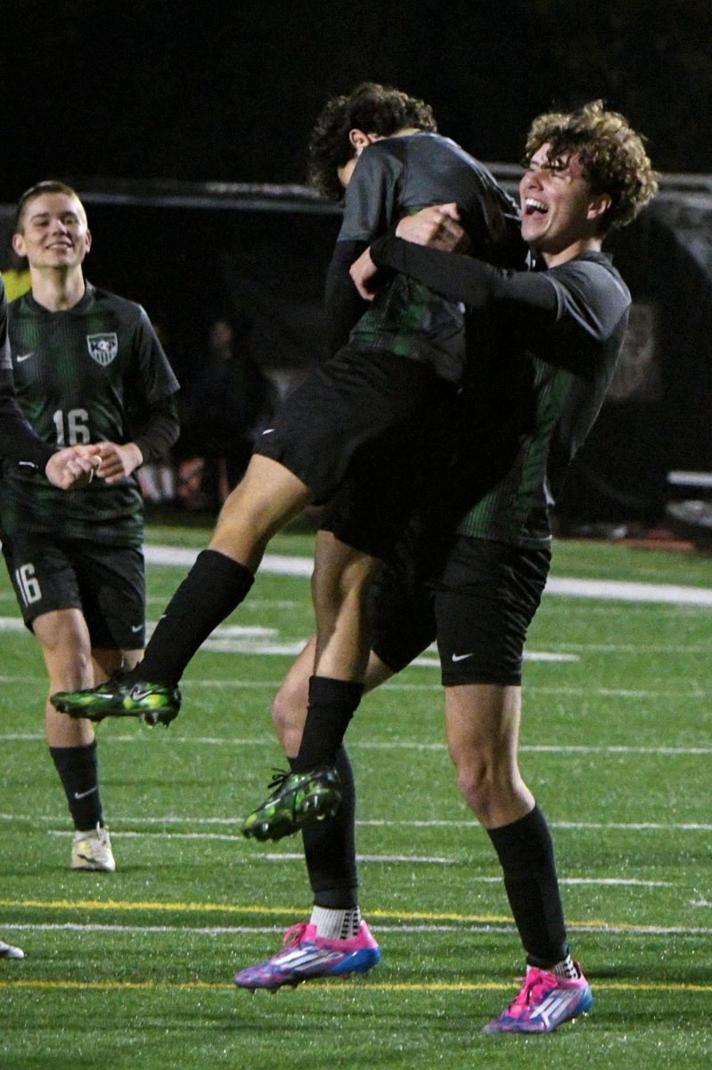 After scoring a penalty kick, senior Stephen Streitman gets picked up by junior Ronan Flaherty in celebration.