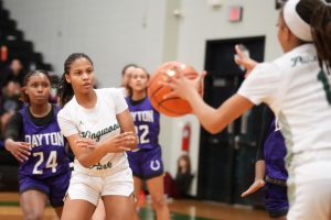 Senior Asia Martin dishes the ball out to her sister Rionna Martin on the perimeter in a game against Dayton on Jan. 28. 