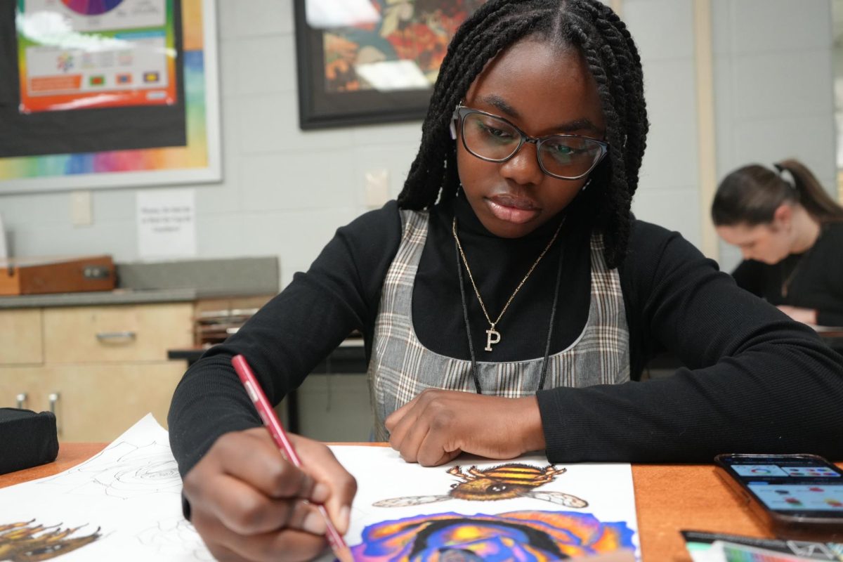 Sophomore Precious Rohr works on art piece in class.