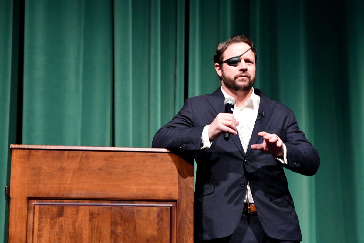 Senator Dan Crenshaw answers questions from students in the auditorium after finishing a talk about his career and leadership. 