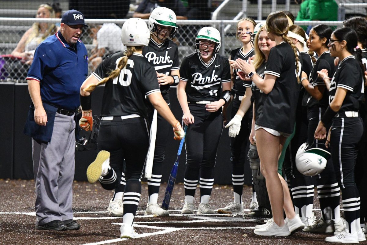 After hitting a home run on March 7 against Pasadena, senior Abbey Papadimitriou celebrates with her teammates at home plate.