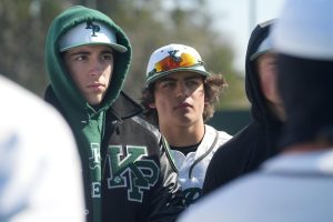 Junior Garrett Koshkin and senior Chris Lora and listen as the coaches given instruction during the Clear Springs tournament game on Feb. 20.