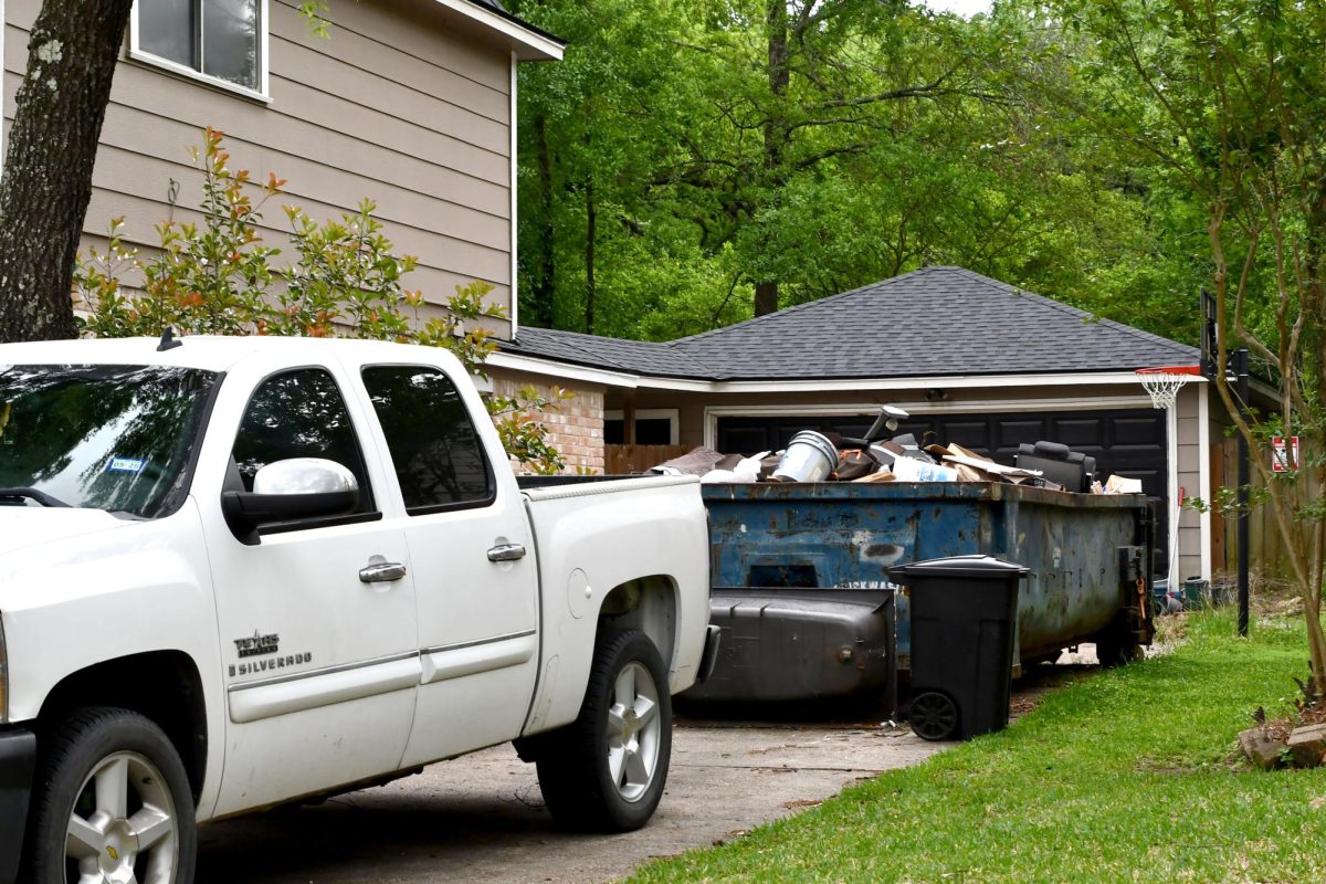 A rented dumpster still sits in Bella and Sophia Bennett's driveway where construction continues on their home, which was damaged during Hurricane Beryl in July. The girls have lived in a rental home with their family the past eight months.