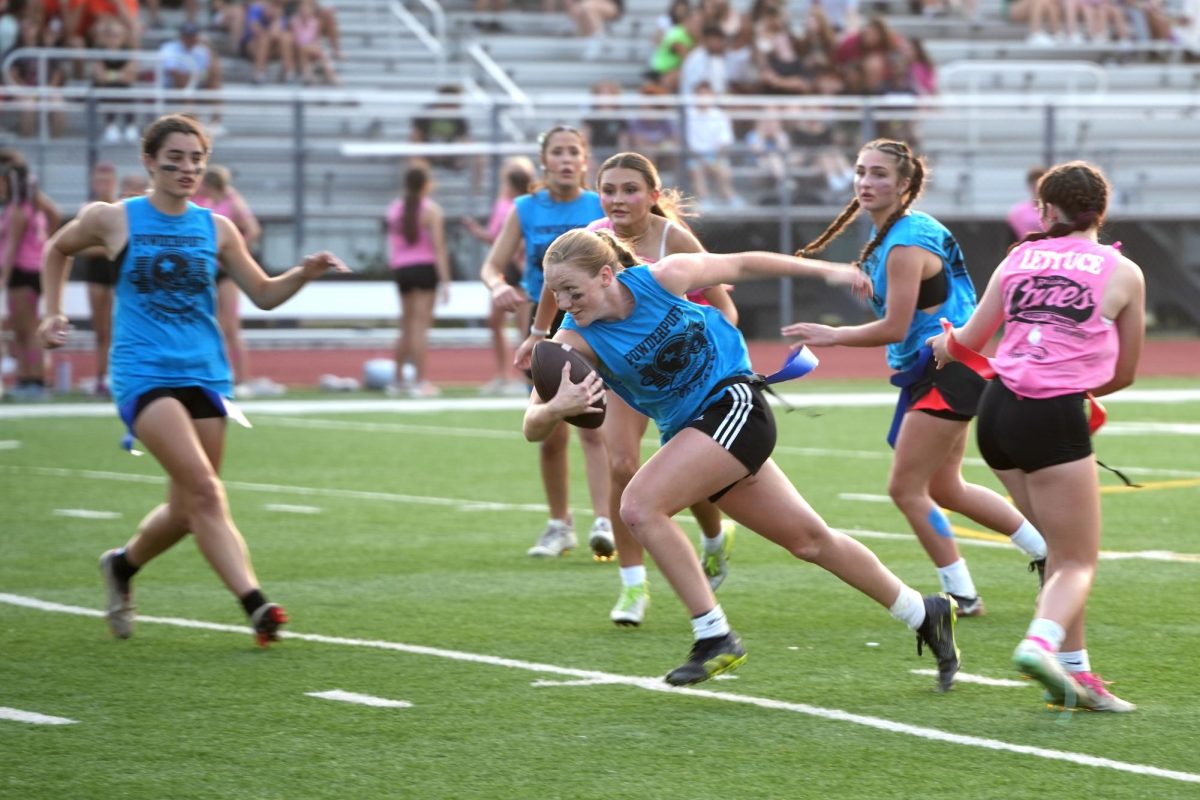 Krisslyn Boyles gains yards on a carry during the championship game at the powderpuff competition on May 16. The seniors beat the sophomores on a last-second goal.