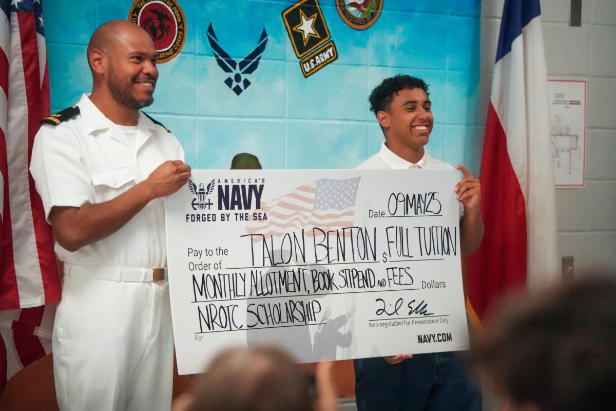 Senior Talon Benton celebrates his full scholarship from the Navy on May 9 at Kingwood Park High School. He will attend Howard University in the fall, and then he will serve at least five years in the Navy after graduation.